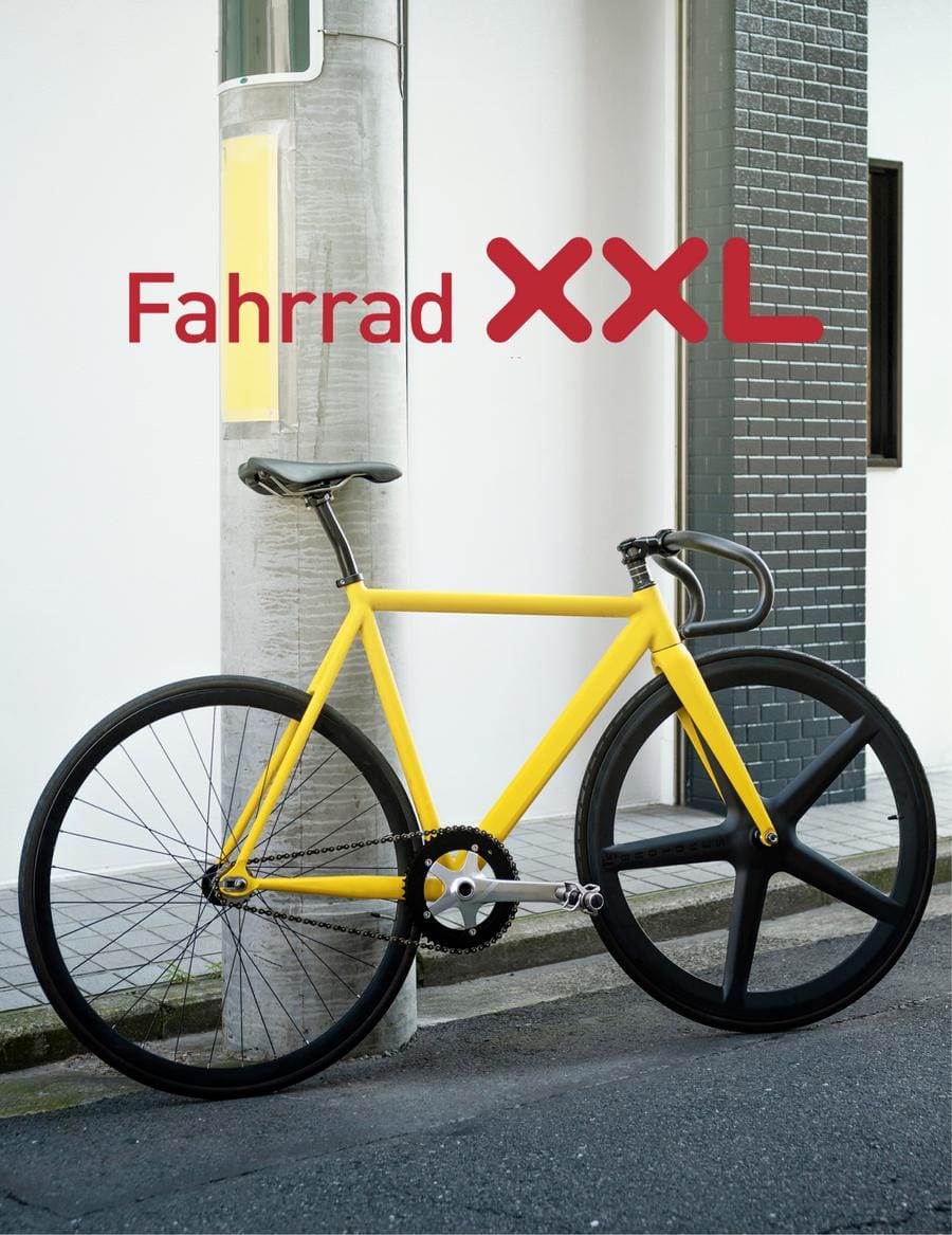 Yellow fixed gear bike leaned against the wall
